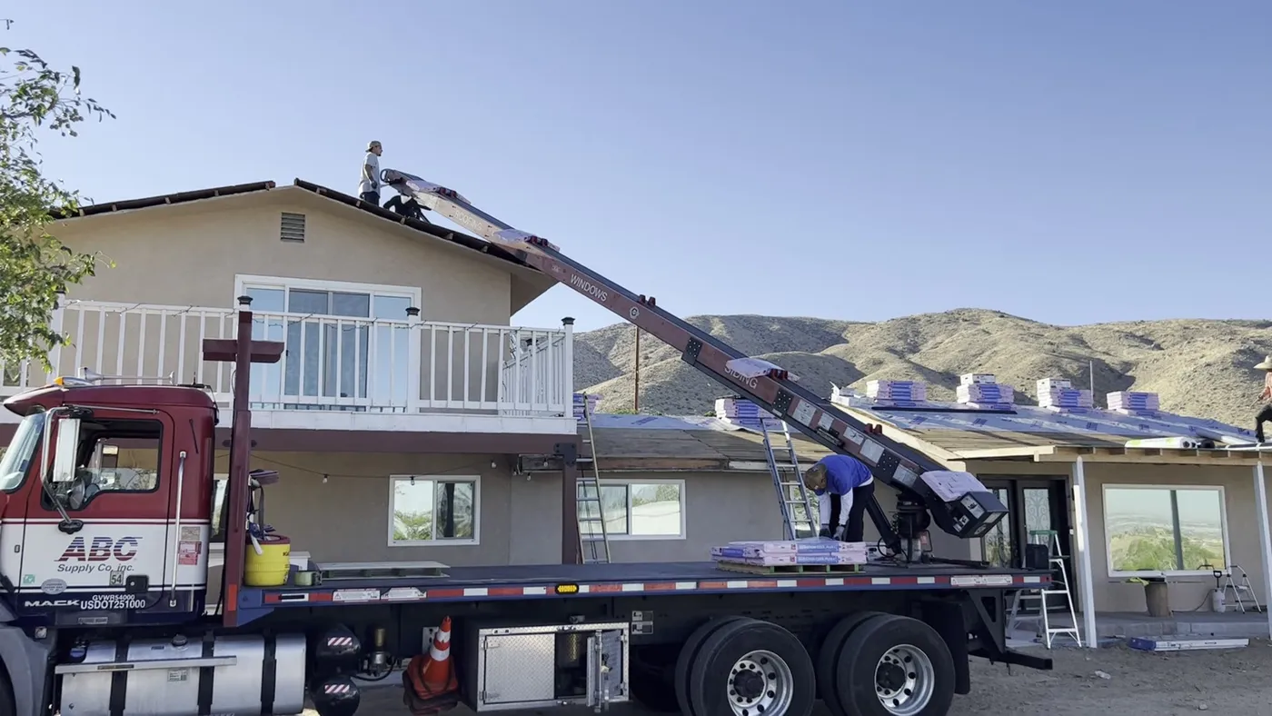 Crane truck delivering roofing materials to a La Habra home